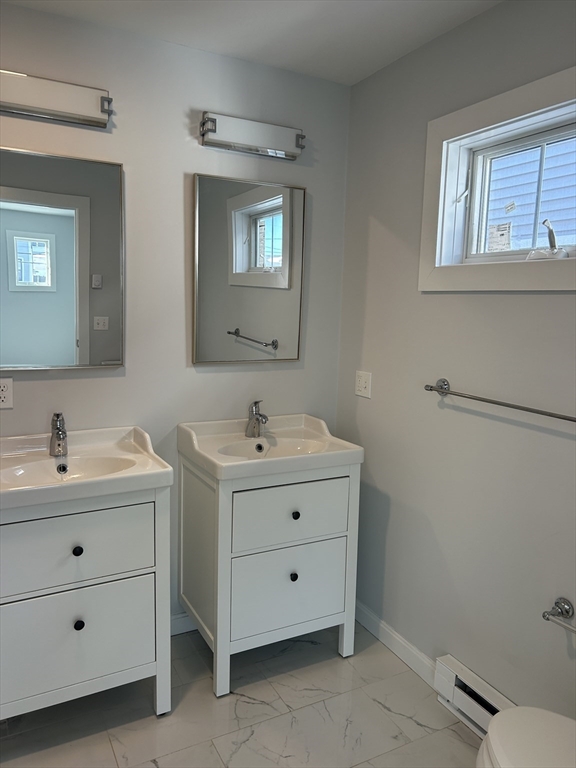 17 North End Boulevard, Unit A Salisbury, MA 01952 - Photo 8 of 13 a bathroom with a double vanity sink and mirror