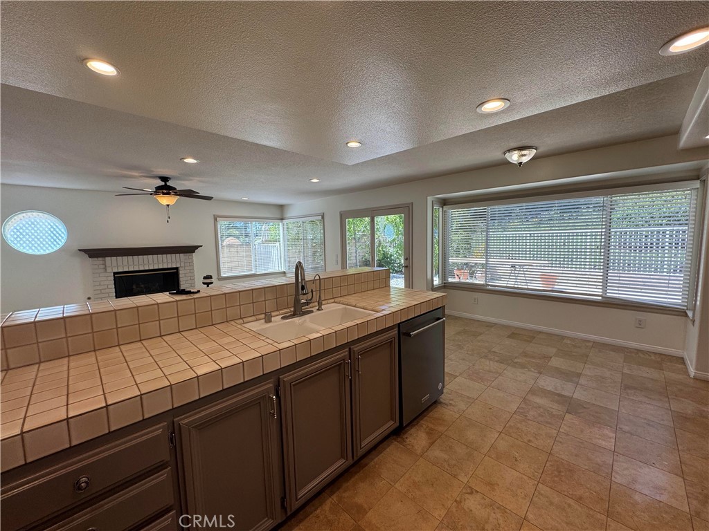 27346 Blueridge Drive Valencia, CA 91354 - Photo 12 of 44 a large kitchen with kitchen island a sink stainless steel appliances and a large window
