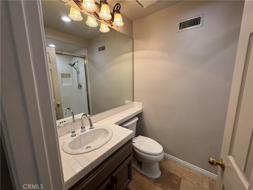 27346 Blueridge Drive Valencia, CA 91354 - Photo 20 of 44 a bathroom with a toilet a sink and mirror