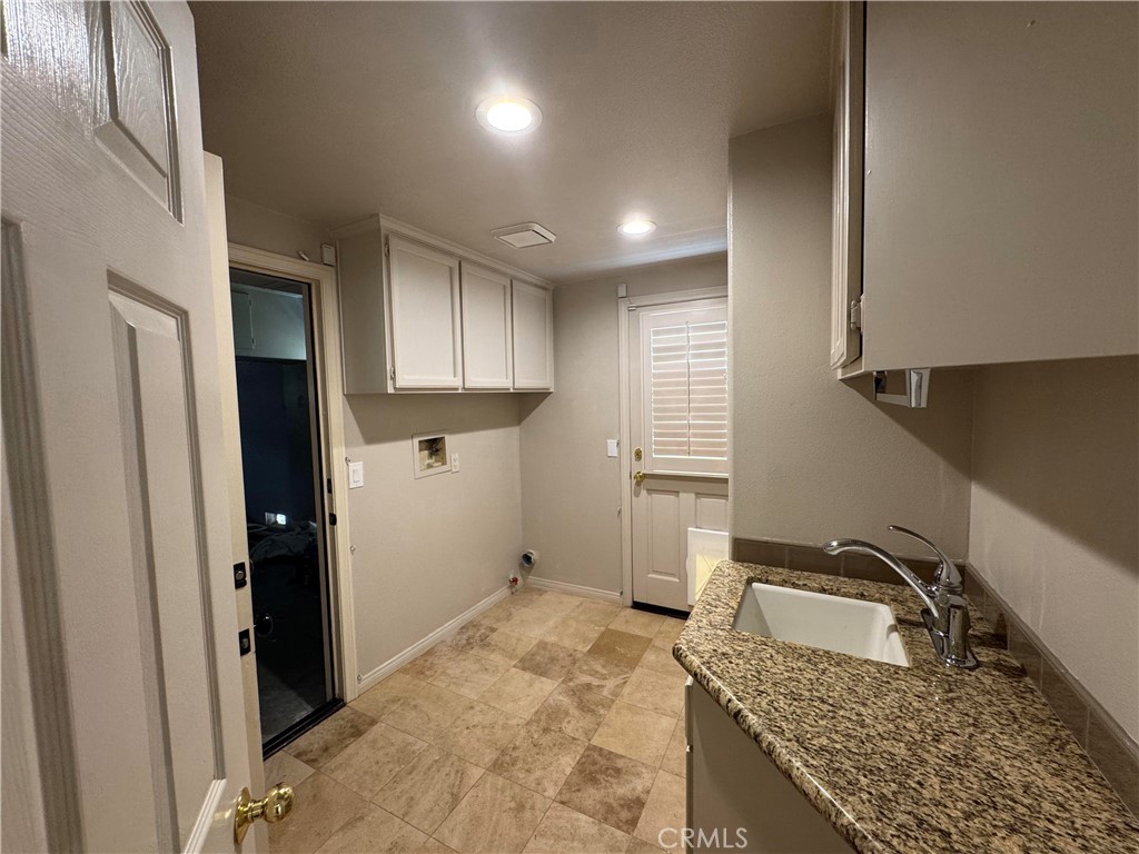 27346 Blueridge Drive Valencia, CA 91354 - Photo 21 of 44 a kitchen with a granite countertop sink a stove and refrigerator
