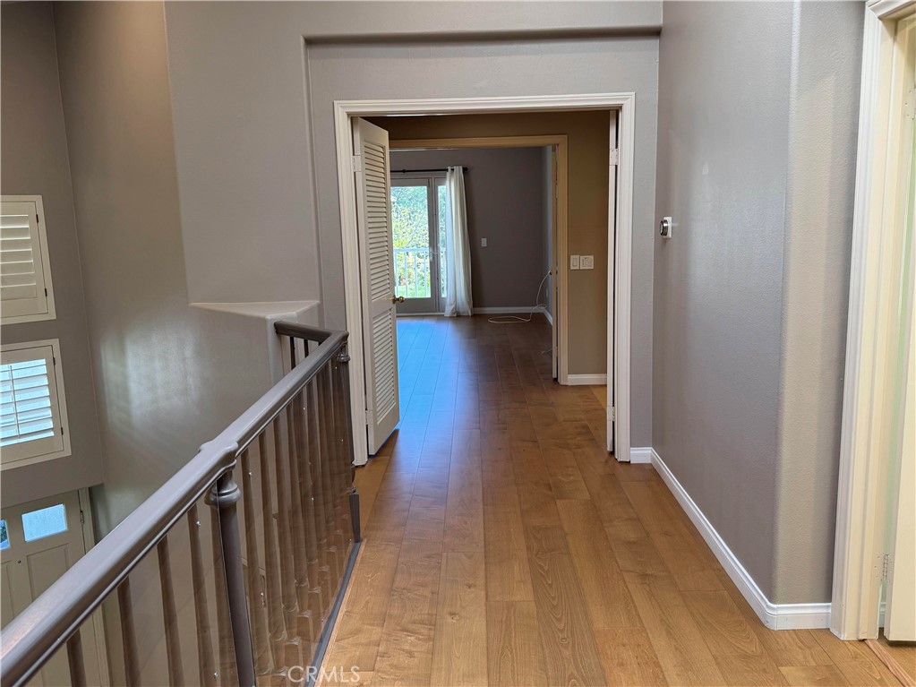 27346 Blueridge Drive Valencia, CA 91354 - Photo 27 of 44 a view of a hallway with wooden floor and stairs