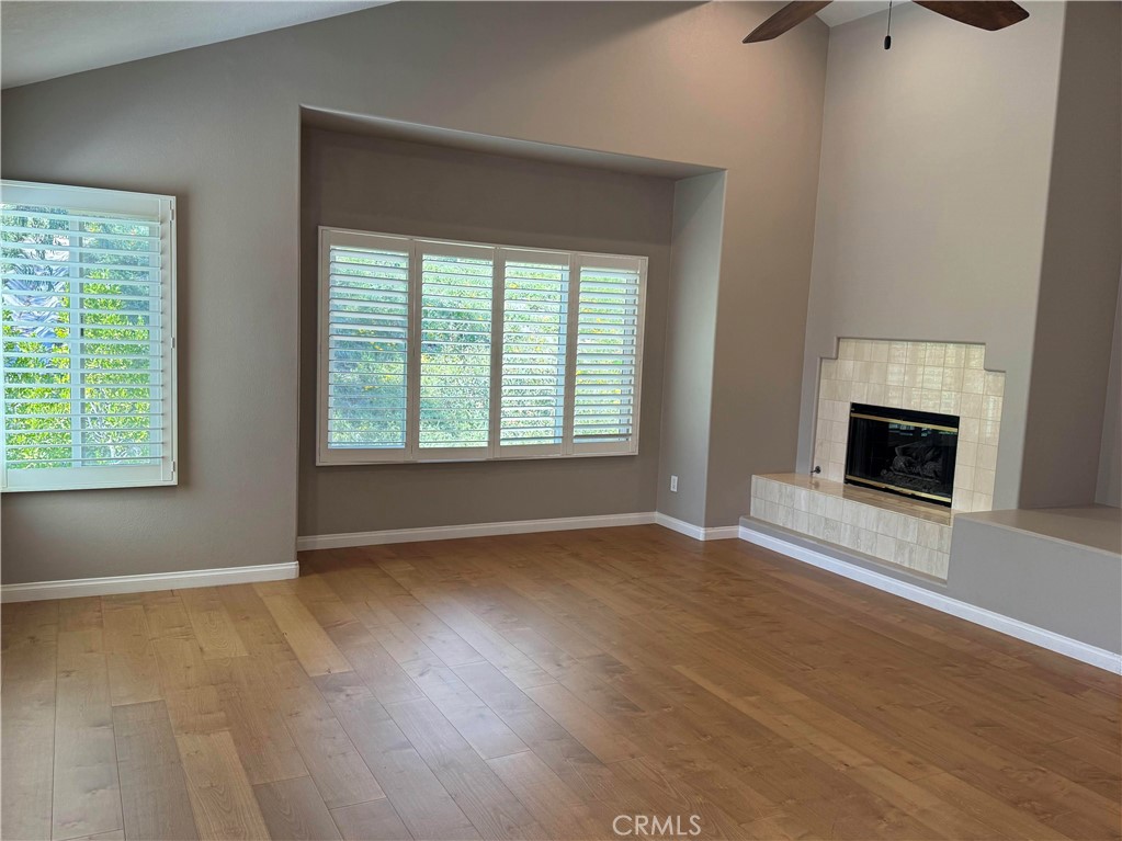 27346 Blueridge Drive Valencia, CA 91354 - Photo 28 of 44 an empty room with wooden floor fireplace and windows