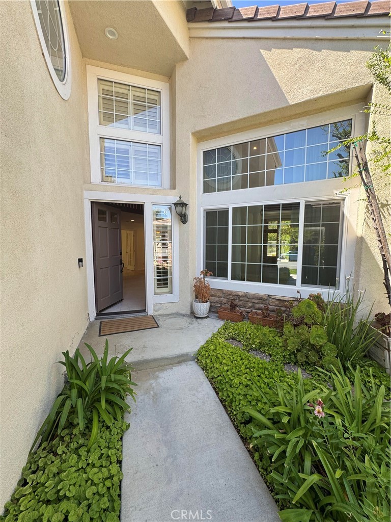 27346 Blueridge Drive Valencia, CA 91354 - Photo 3 of 44 a front view of a house with a yard and potted plants