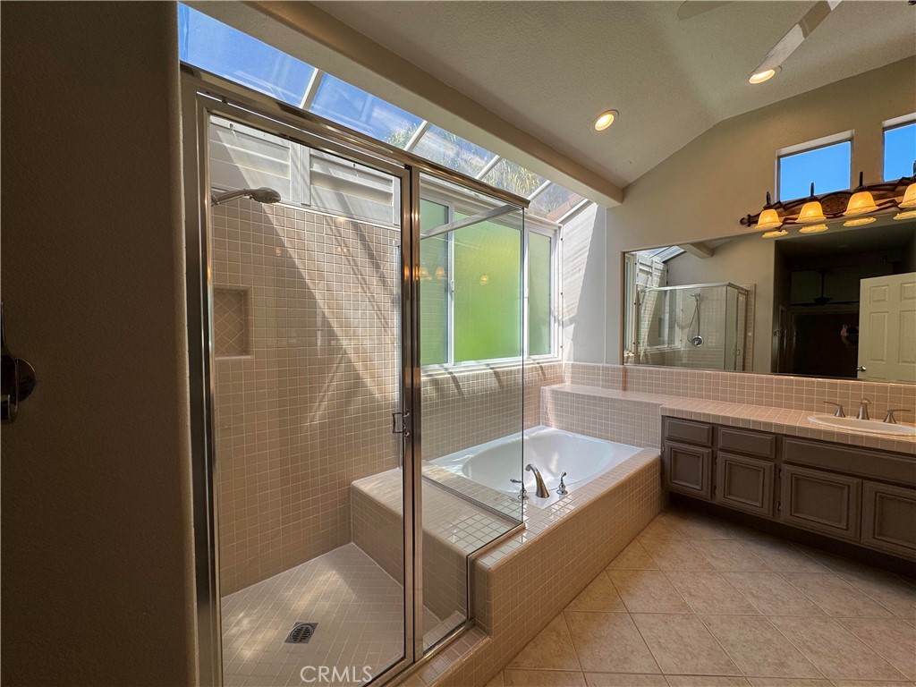 27346 Blueridge Drive Valencia, CA 91354 - Photo 32 of 44 a bathroom with a tub a sink and mirrors