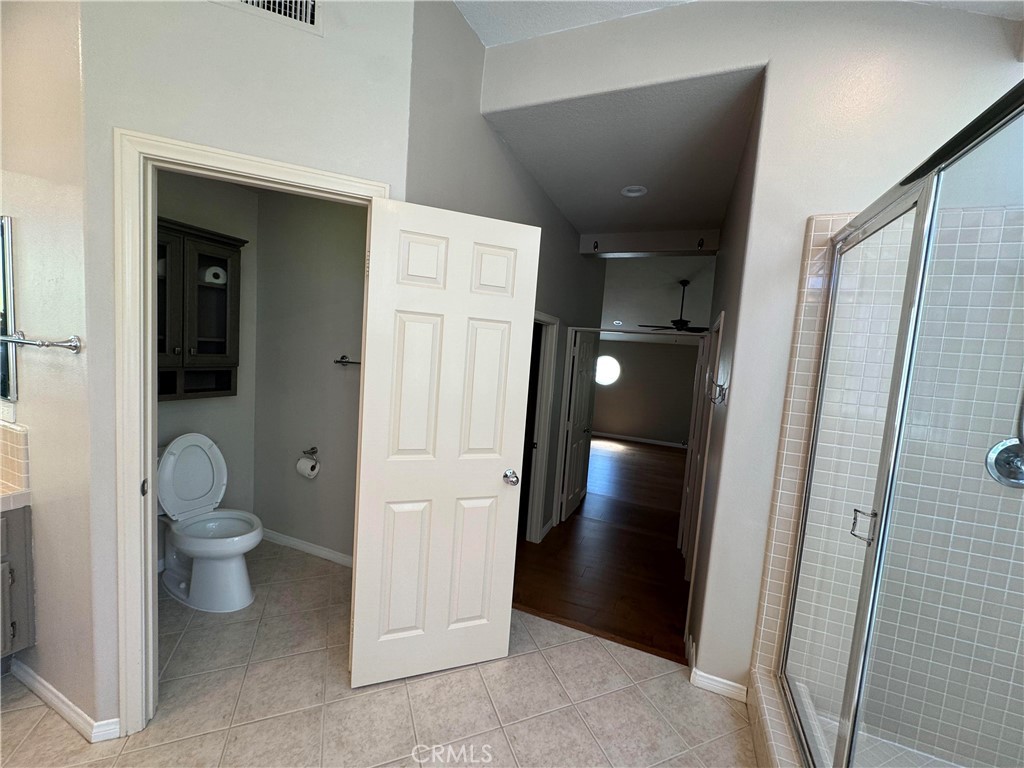 27346 Blueridge Drive Valencia, CA 91354 - Photo 33 of 44 a bathroom with a toilet and a glass door shower