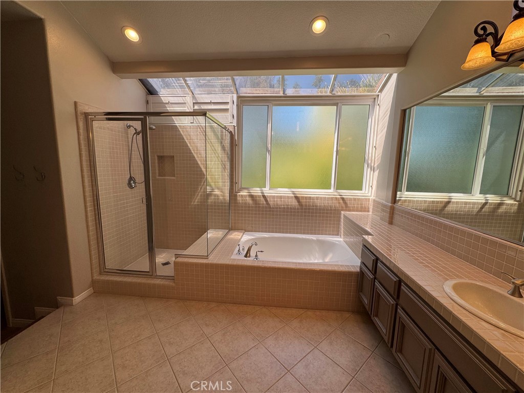 27346 Blueridge Drive Valencia, CA 91354 - Photo 36 of 44 a bathroom with a tub a sink and a large mirror