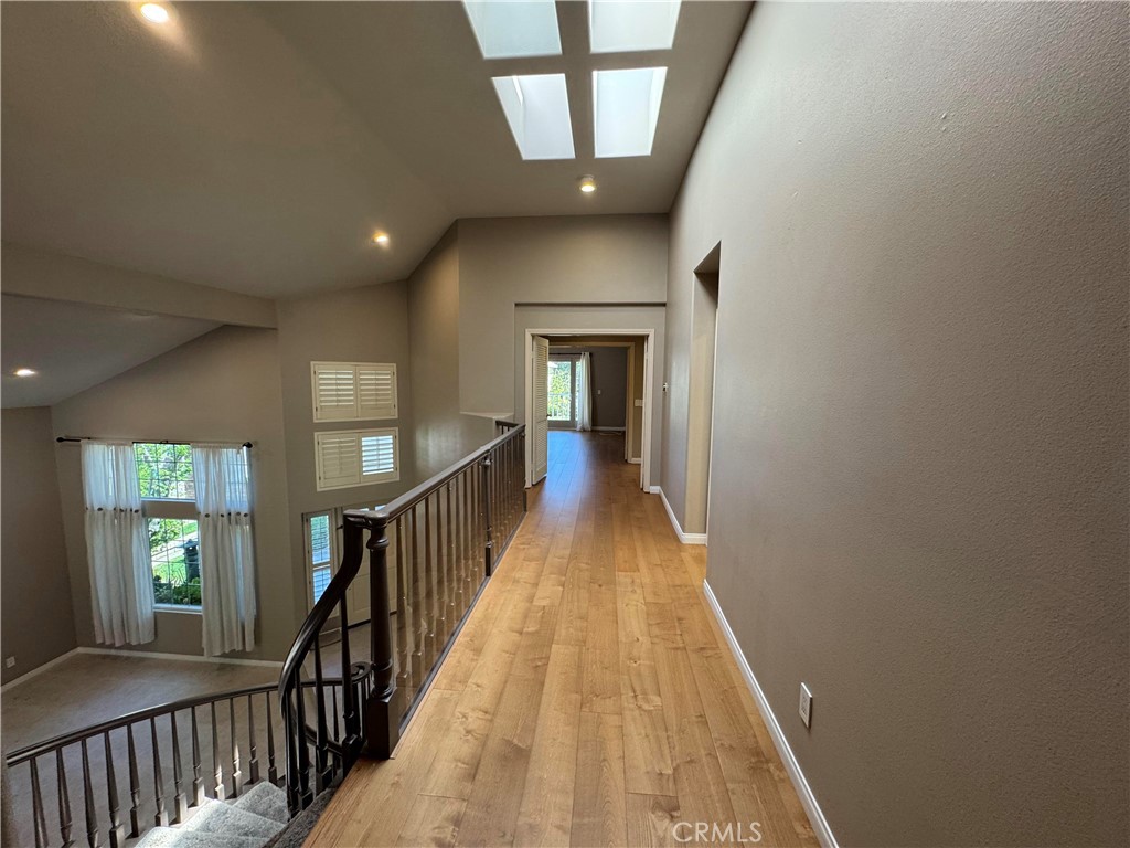 27346 Blueridge Drive Valencia, CA 91354 - Photo 37 of 44 a view of a hallway with wooden floor and stairs
