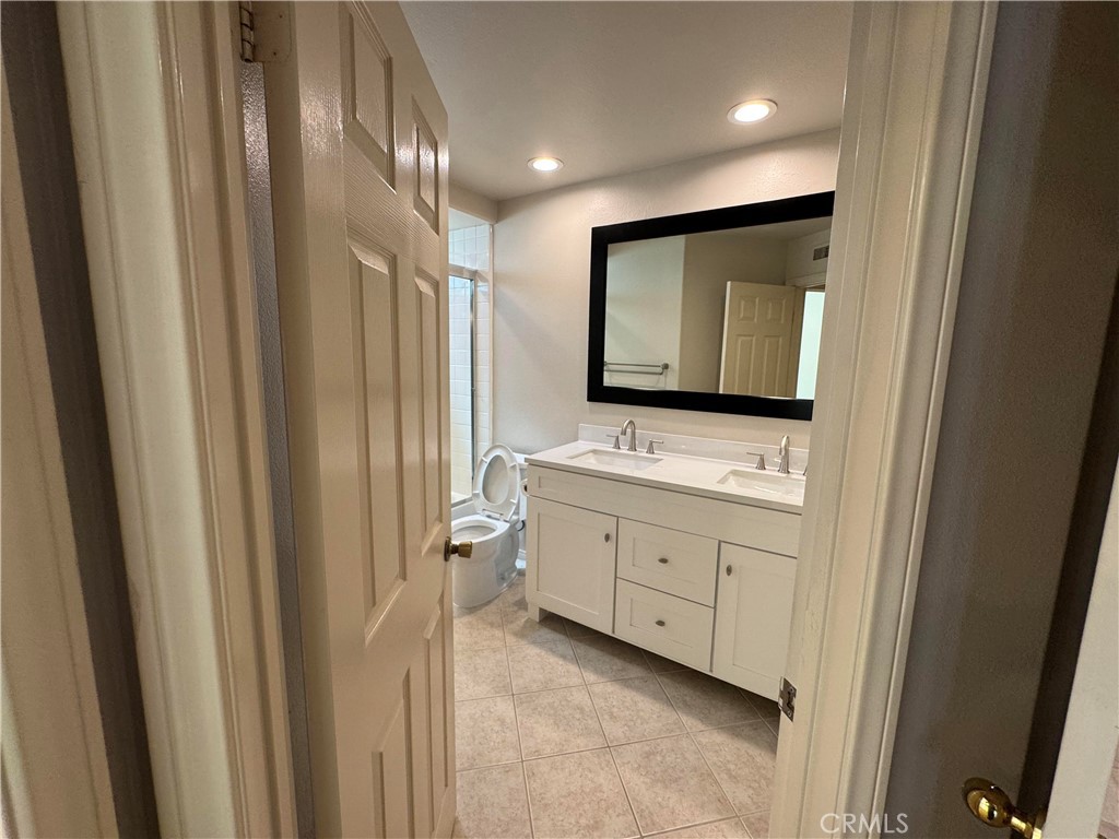 27346 Blueridge Drive Valencia, CA 91354 - Photo 40 of 44 a bathroom with double sink and mirror