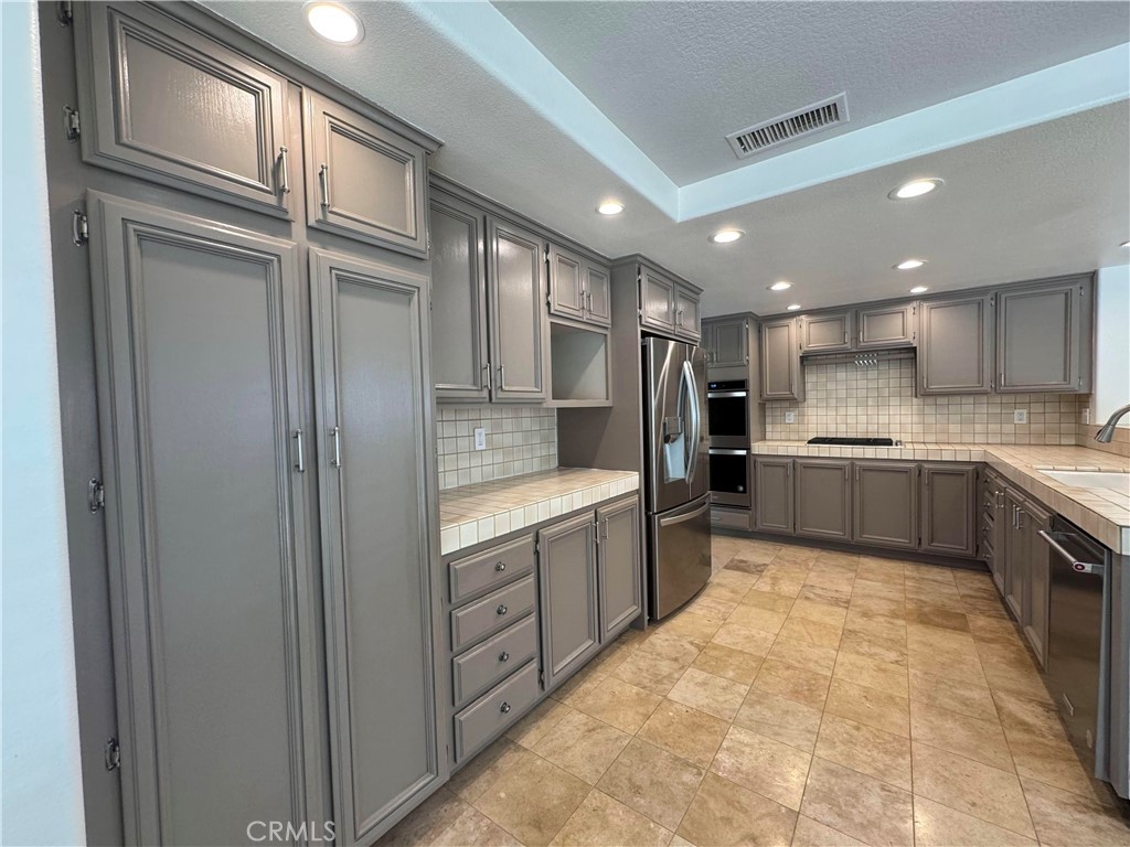 27346 Blueridge Drive Valencia, CA 91354 - Photo 10 of 44 a large kitchen with stainless steel appliances granite countertop a refrigerator and a sink