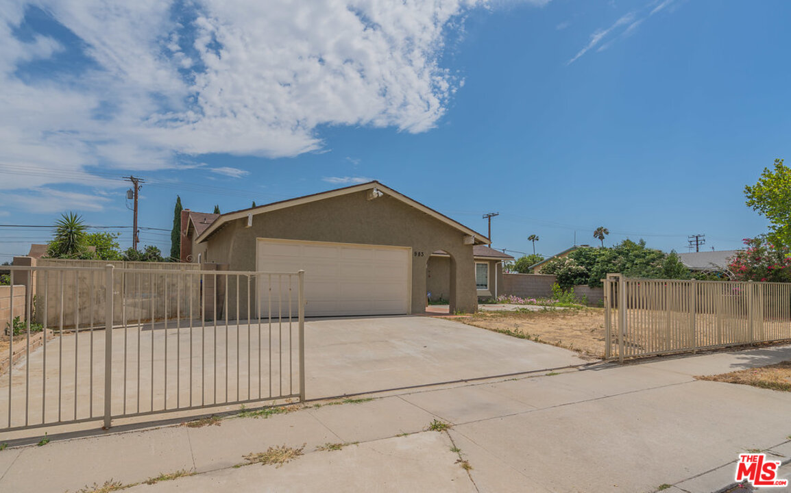 983 East Margarita Road Rialto, CA 92376 - Photo 2 of 23 a view of a house with a small yard and large tree