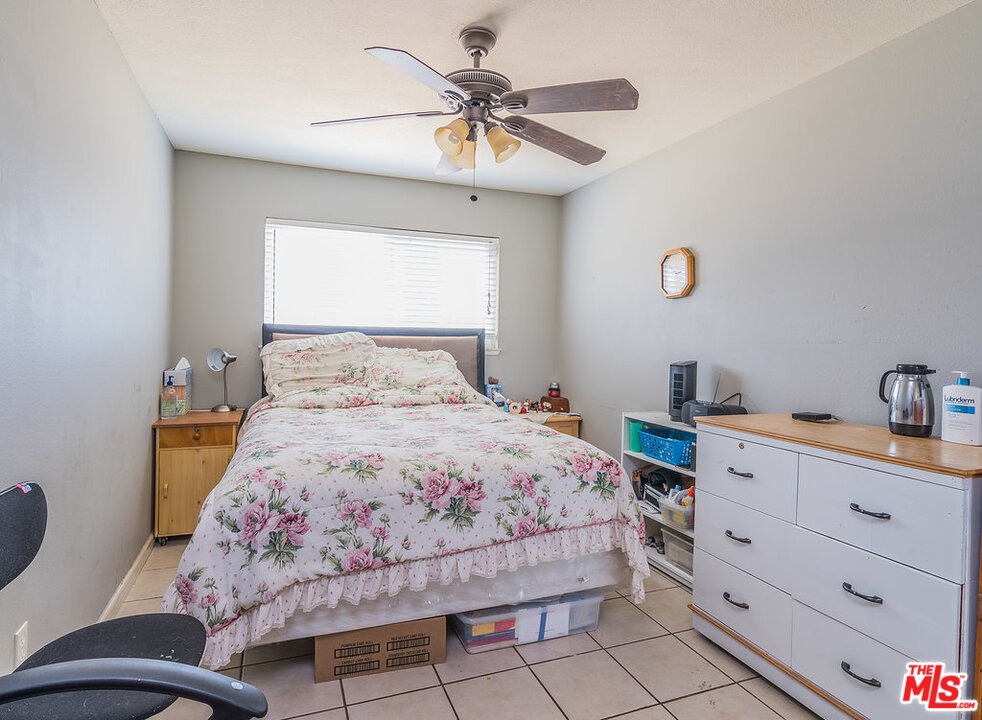 983 East Margarita Road Rialto, CA 92376 - Photo 13 of 23 a bedroom with a bed and a chandelier