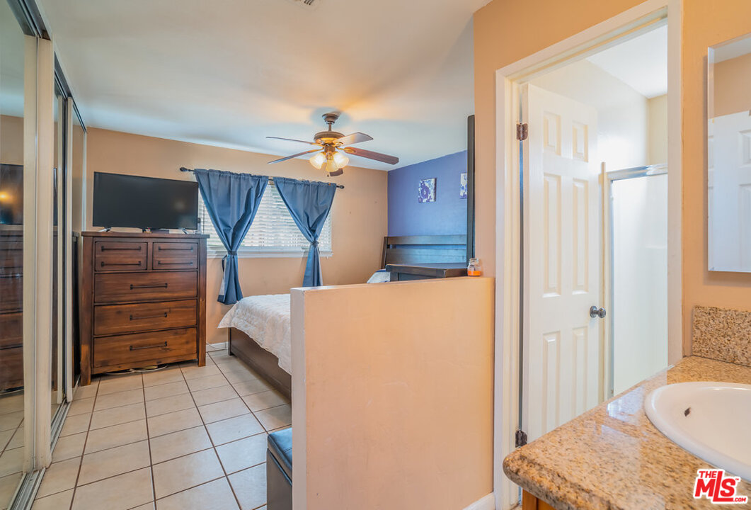 983 East Margarita Road Rialto, CA 92376 - Photo 15 of 23 a bedroom with a bed and a chandelier