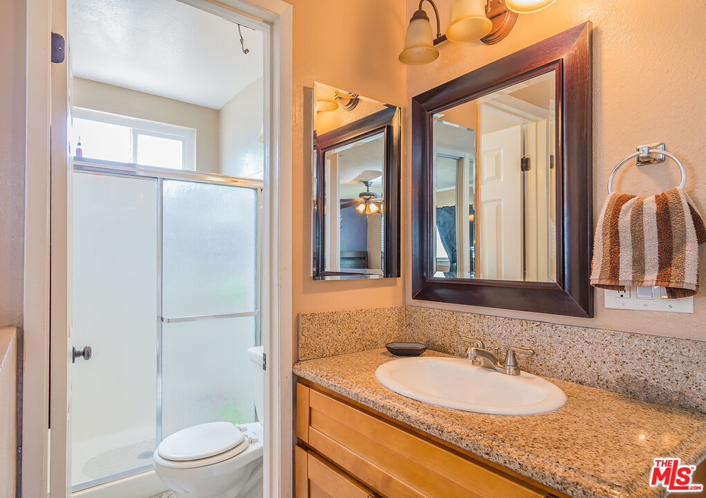 983 East Margarita Road Rialto, CA 92376 - Photo 16 of 23 a bathroom with a granite countertop sink toilet and shower