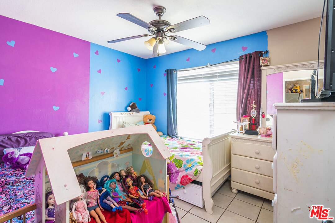 983 East Margarita Road Rialto, CA 92376 - Photo 19 of 23 a kids bedroom with a bed and furniture