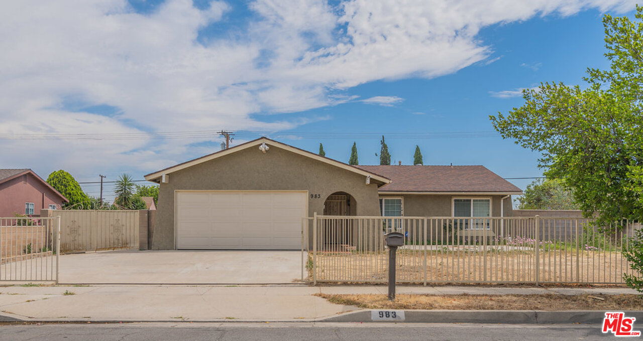 983 East Margarita Road Rialto, CA 92376 - Photo 3 of 23 a front view of a house with a garden