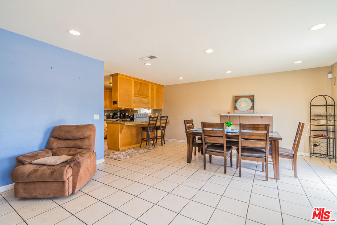 983 East Margarita Road Rialto, CA 92376 - Photo 6 of 23 a dining room with furniture a rug and a kitchen