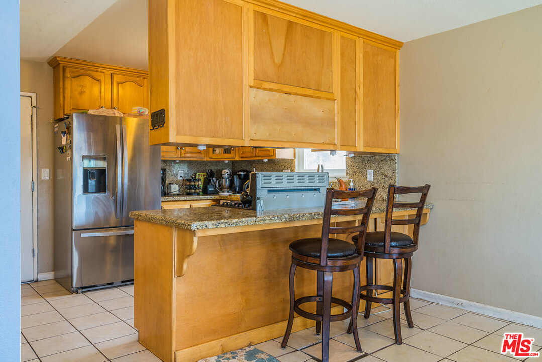 983 East Margarita Road Rialto, CA 92376 - Photo 9 of 23 a kitchen with a stove a refrigerator and a table