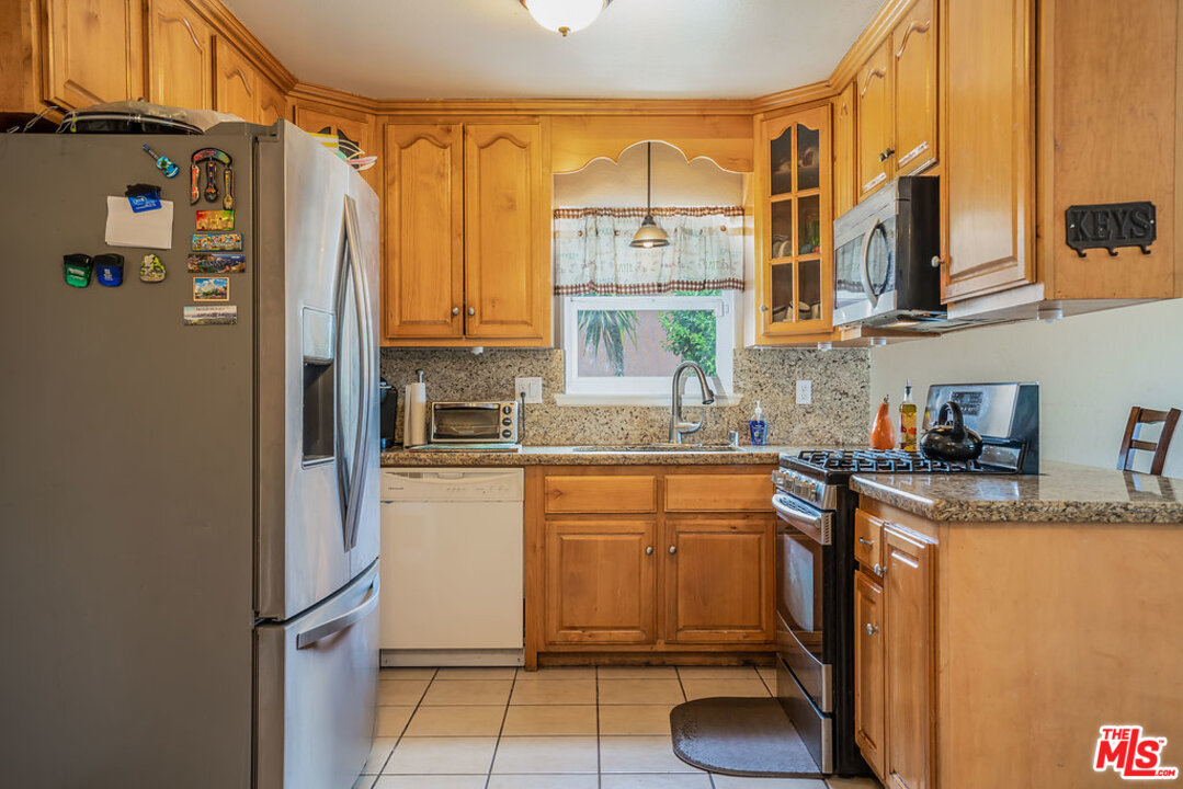 983 East Margarita Road Rialto, CA 92376 - Photo 10 of 23 a kitchen with stainless steel appliances granite countertop a refrigerator and a sink