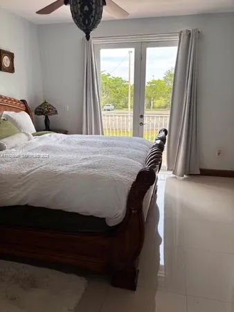 a bed sitting in a bedroom next to a window