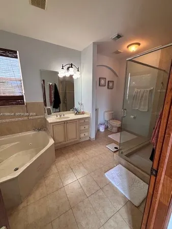 a spacious bathroom with a sink a mirror and bathtub