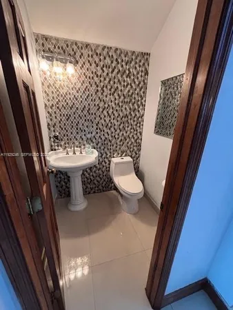 a bathroom with a toilet and a shower curtain