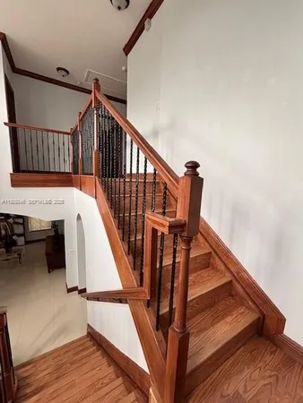 a view of entryway and hall with wooden floor