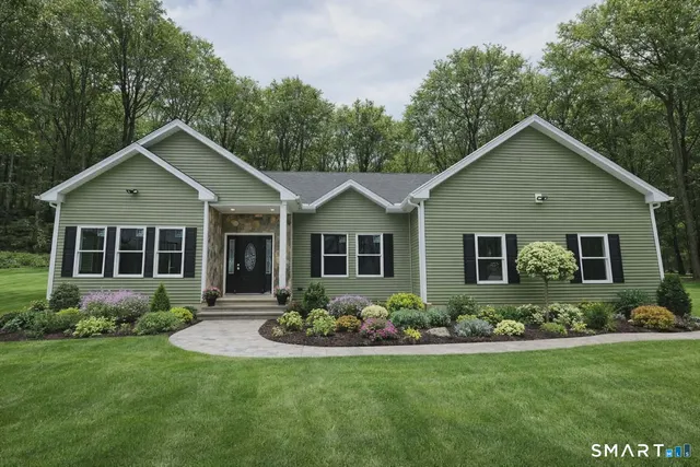 a front view of a house with garden