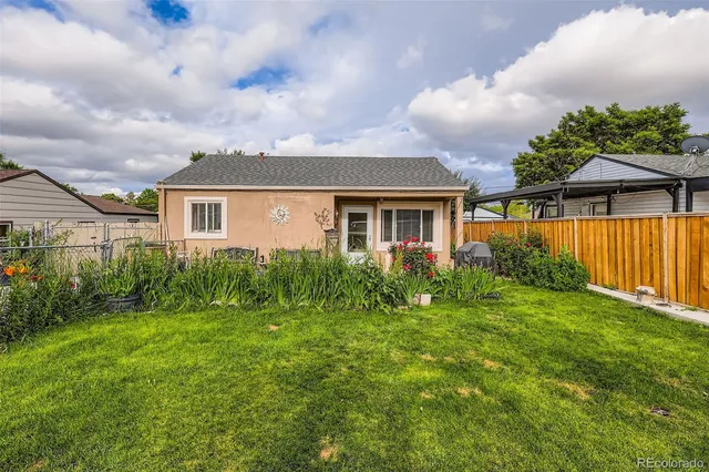 a view of backyard of house with green space