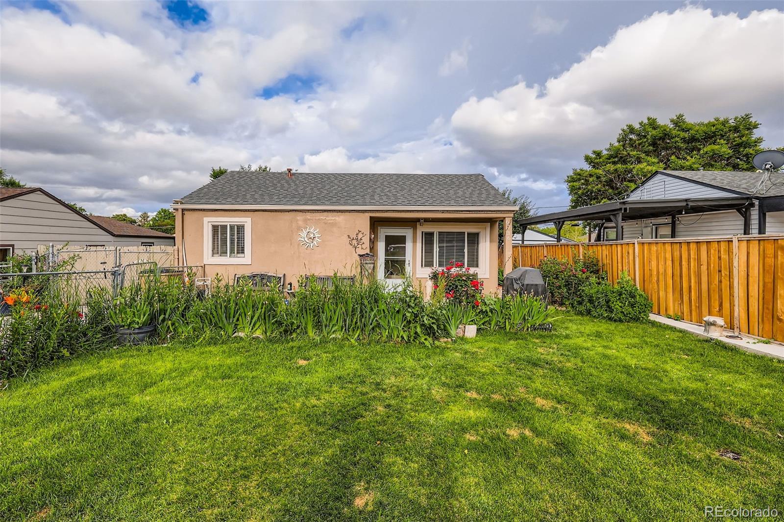 a view of backyard of house with green space
