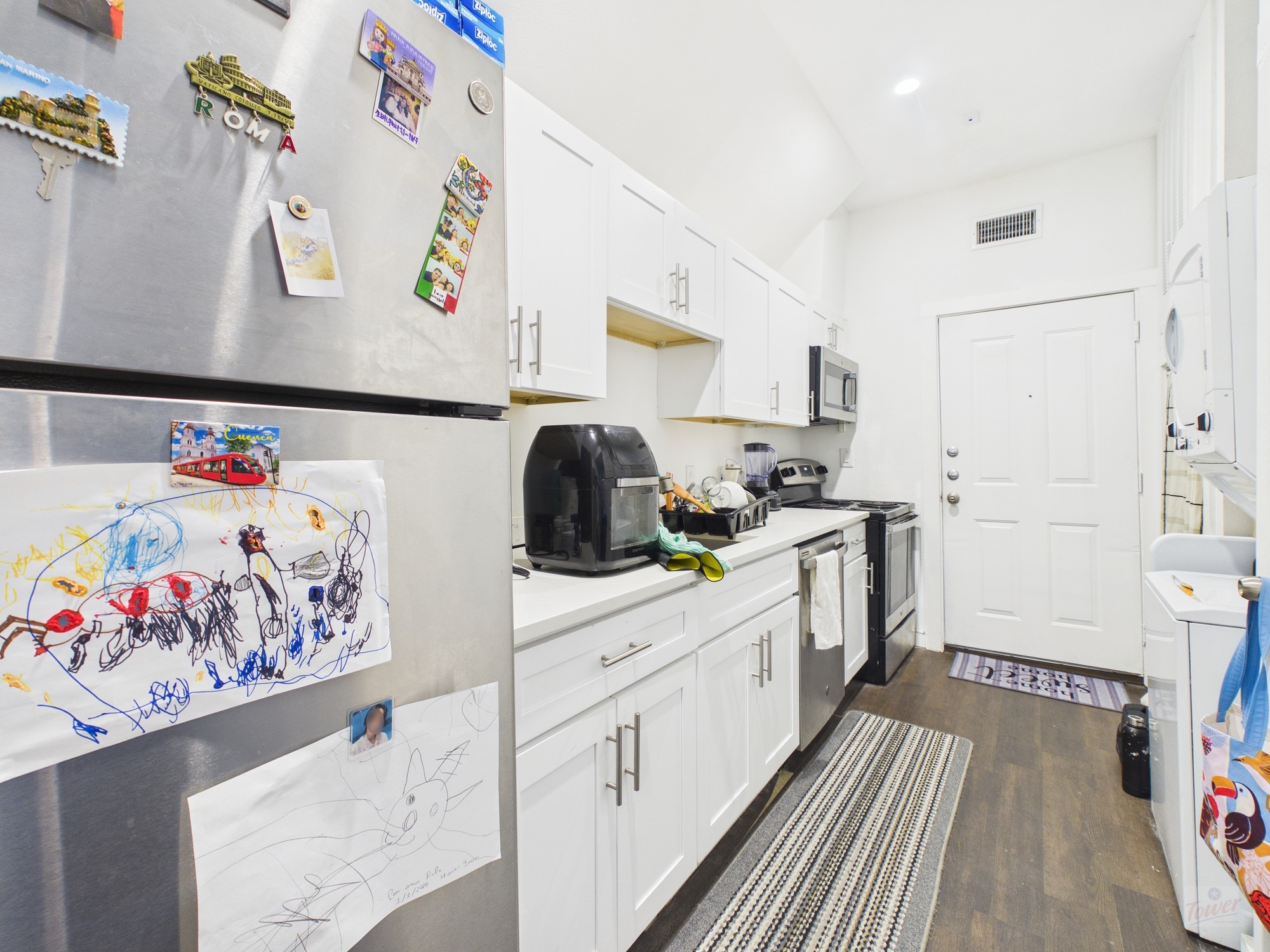 1010 West 26th Street, Unit 403 Austin, TX 78705 - Photo 2 of 6 a kitchen with white cabinets stove and white appliances