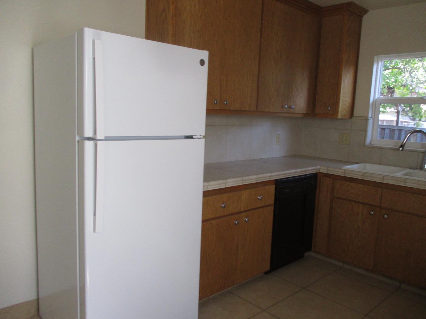 Murray Avenue Gilroy, CA 95020 - Photo 12 of 25 a kitchen with a refrigerator and cabinets