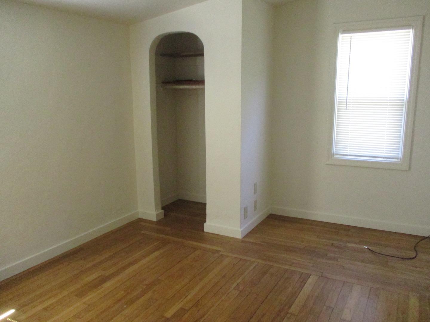 Murray Avenue Gilroy, CA 95020 - Photo 19 of 25 an empty room with wooden floor and windows