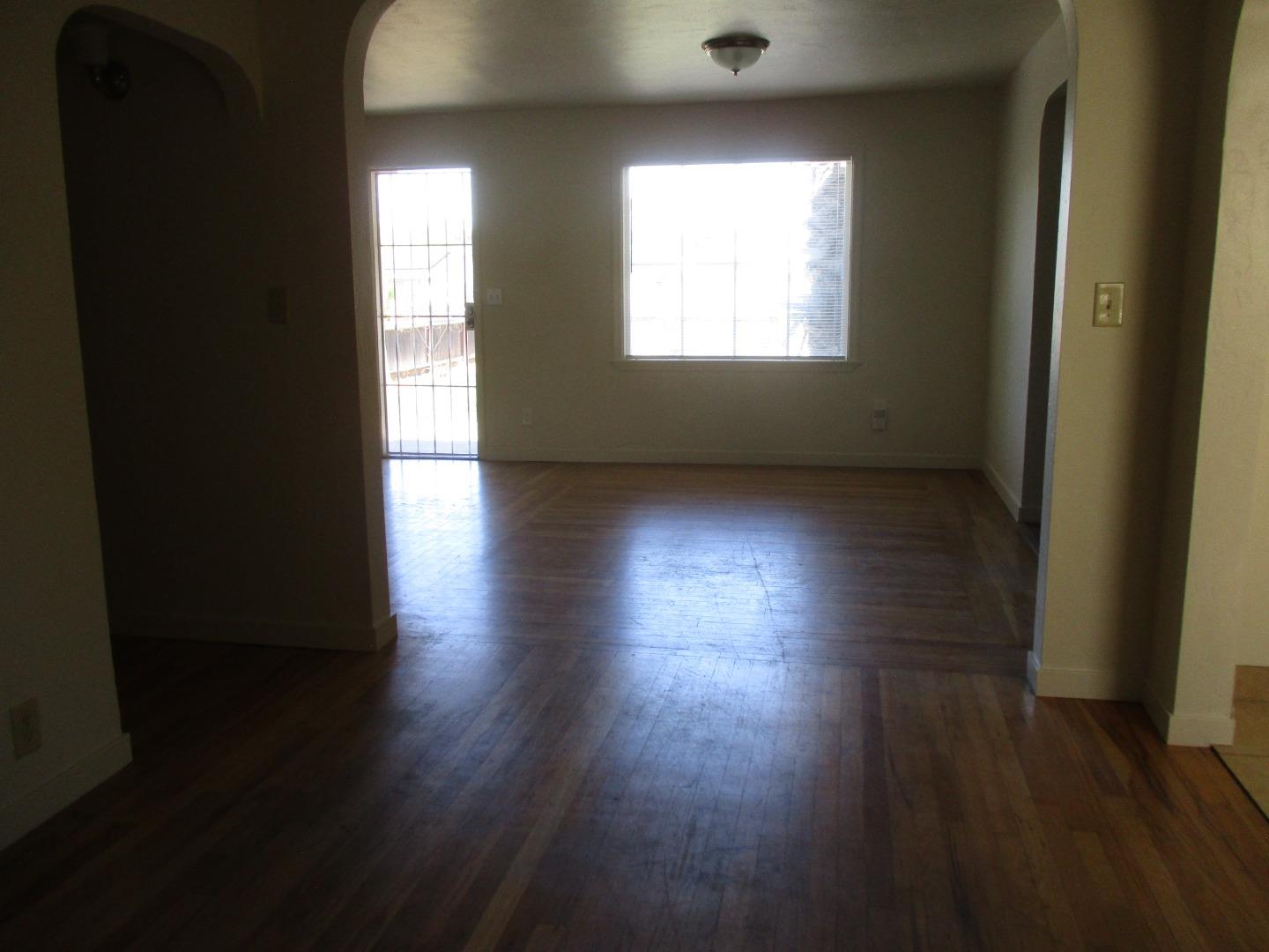 Murray Avenue Gilroy, CA 95020 - Photo 9 of 25 an empty room with wooden floor and windows