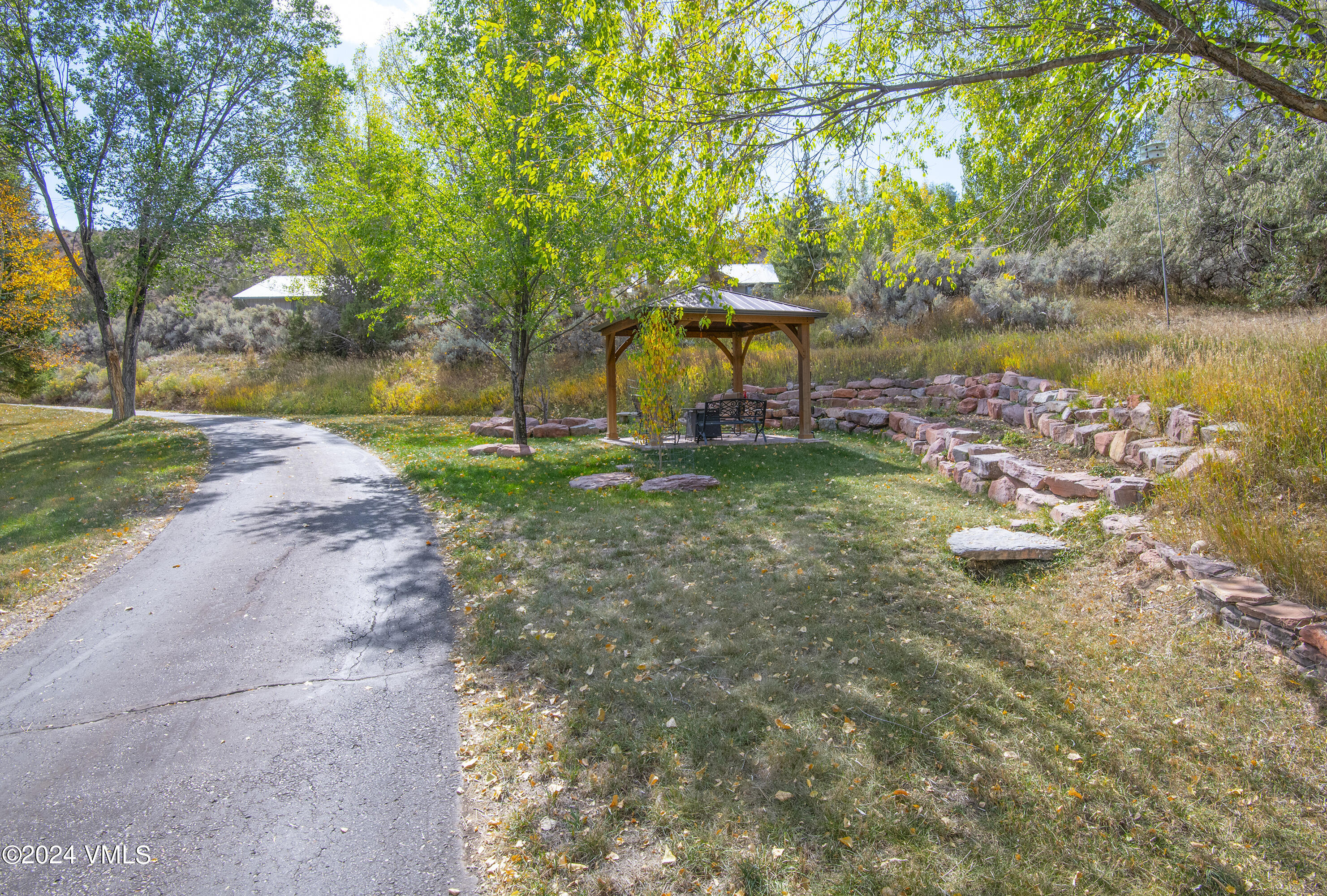 220 Beacon Road Gypsum, CO 81637 - Photo 3 of 12 a backyard of a house with yard and outdoor seating
