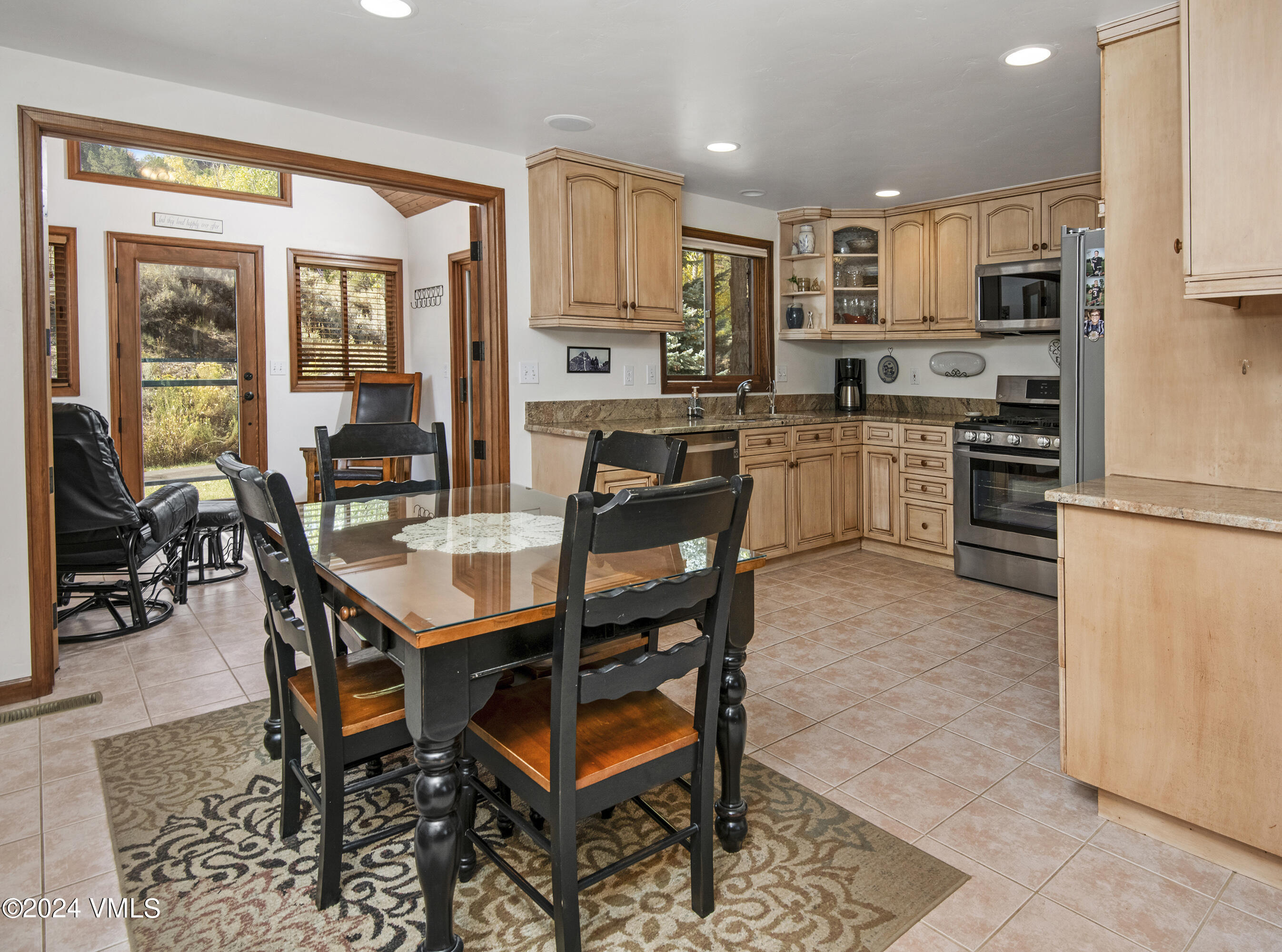 220 Beacon Road Gypsum, CO 81637 - Photo 5 of 12 a kitchen with a dining table chairs and refrigerator