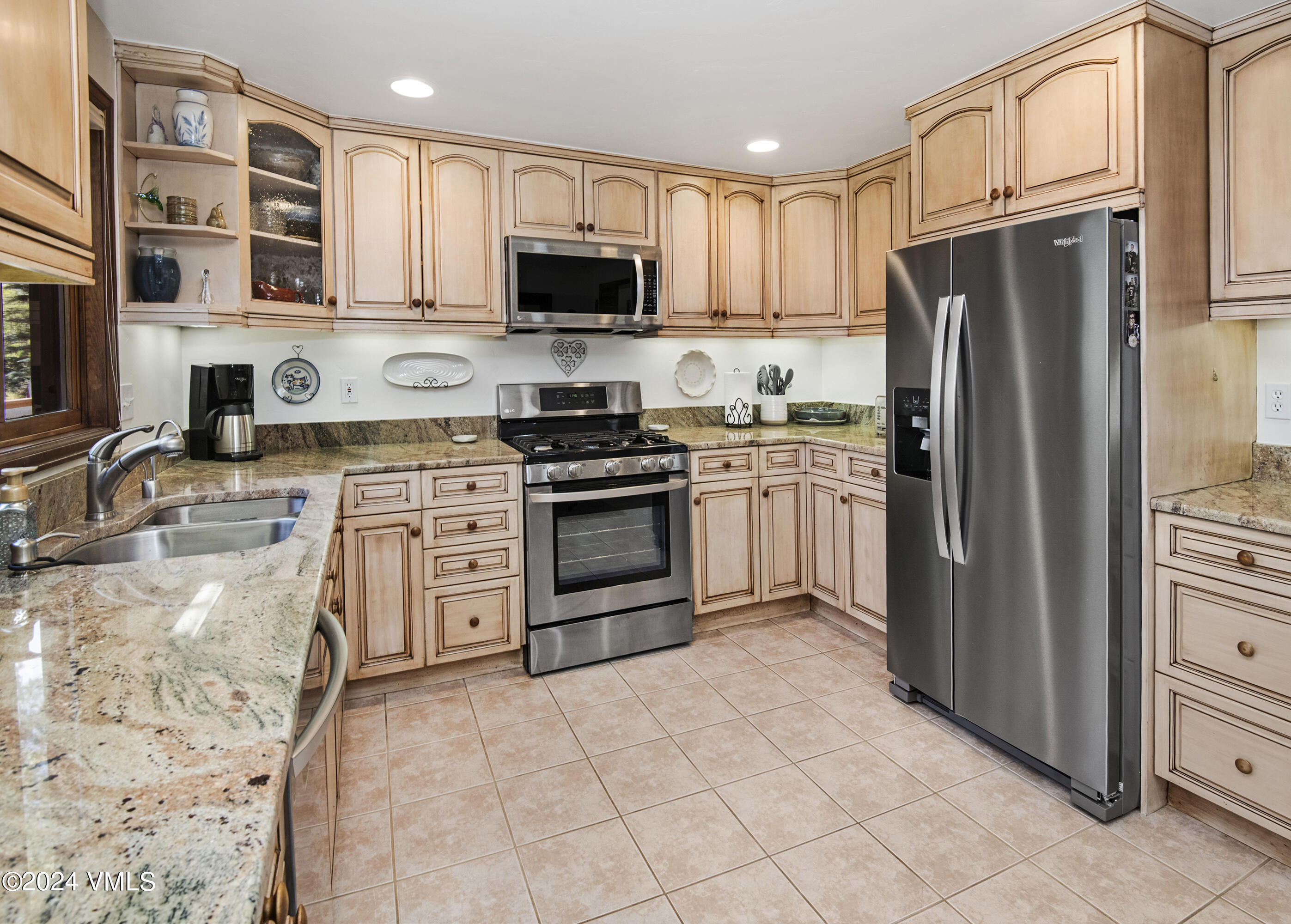 220 Beacon Road Gypsum, CO 81637 - Photo 6 of 12 a kitchen with stainless steel appliances granite countertop a stove top oven a refrigerator and a sink with granite countertops