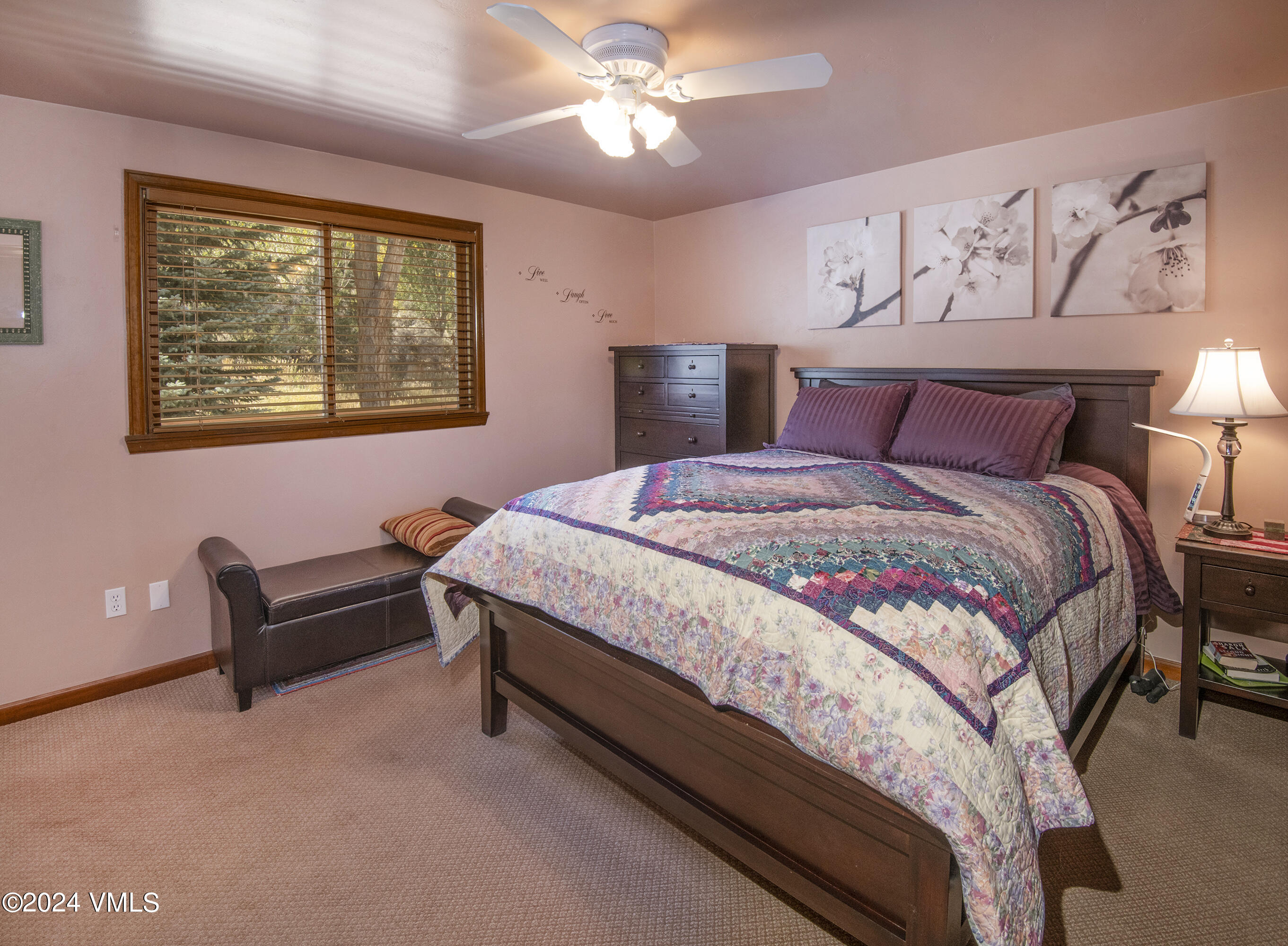 220 Beacon Road Gypsum, CO 81637 - Photo 7 of 12 a bedroom with a bed and a chandelier