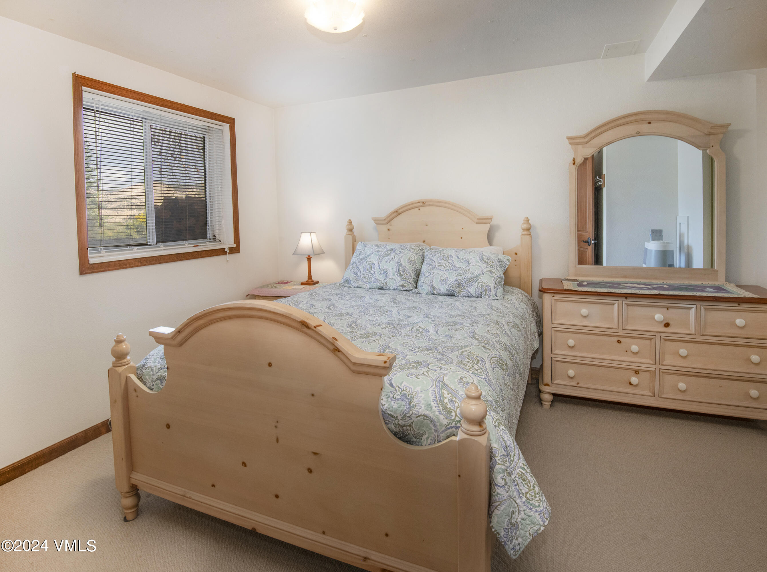 220 Beacon Road Gypsum, CO 81637 - Photo 8 of 12 a bedroom with a bed and a dresser