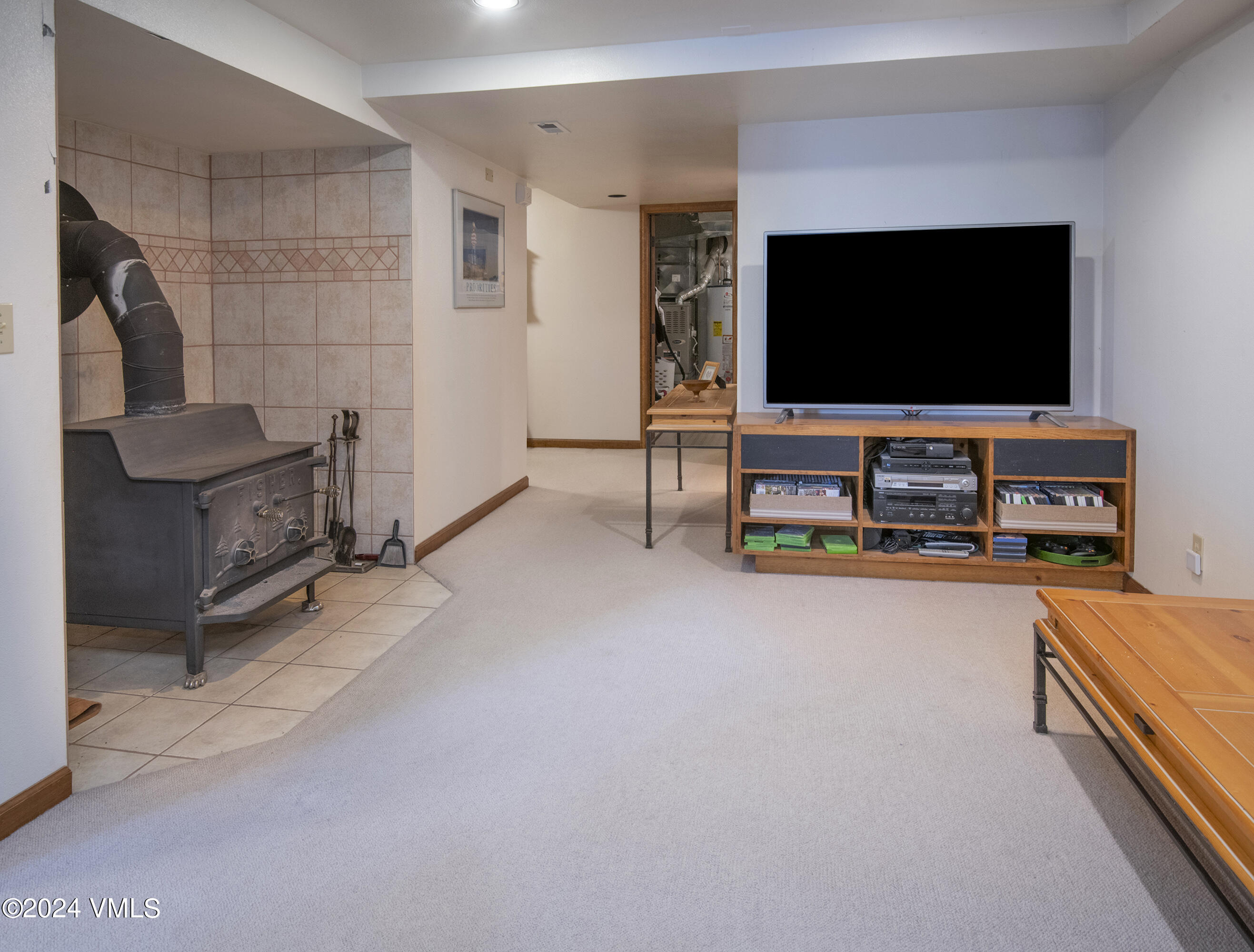 220 Beacon Road Gypsum, CO 81637 - Photo 10 of 12 a living room with furniture and a flat screen tv