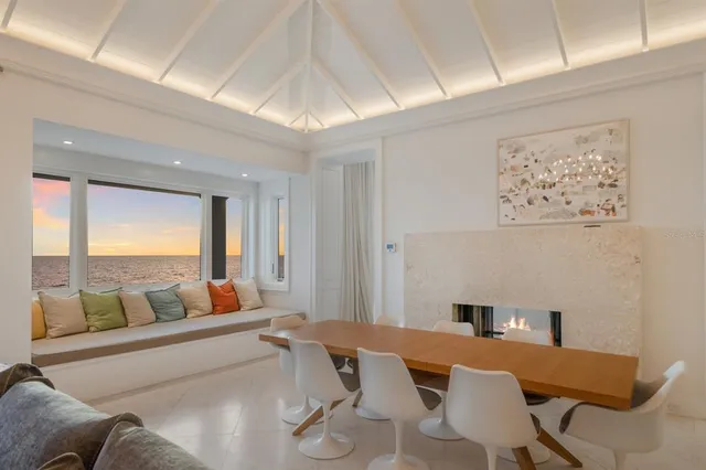 a living room with stainless steel appliances kitchen island a table and chairs