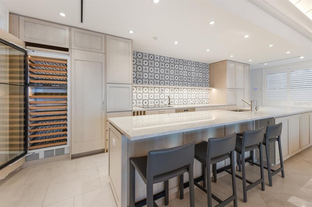 2031 Shore Lane Boca Grande, FL 33921 - Photo 23 of 100 a kitchen with kitchen island a sink table and chairs