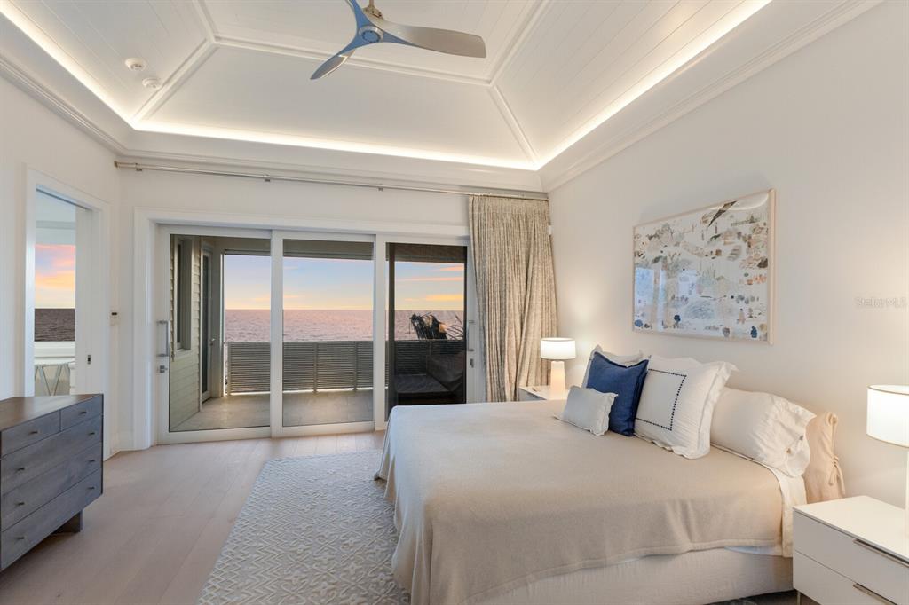 2031 Shore Lane Boca Grande, FL 33921 - Photo 28 of 100 a bedroom with a large bed and a chandelier