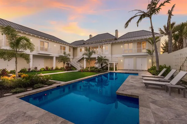 a view of a house with backyard and sitting area