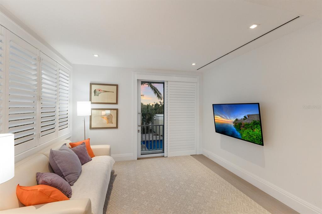 2031 Shore Lane Boca Grande, FL 33921 - Photo 31 of 100 a living room with furniture a flat screen tv and a window