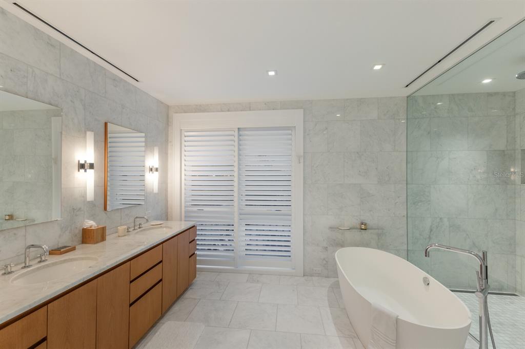 2031 Shore Lane Boca Grande, FL 33921 - Photo 33 of 100 a bathroom with a double vanity sink toilet and shower