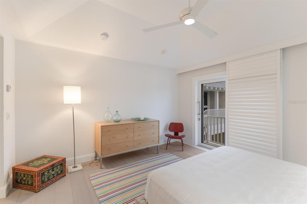 2031 Shore Lane Boca Grande, FL 33921 - Photo 38 of 100 a bedroom with a bed and a lamp