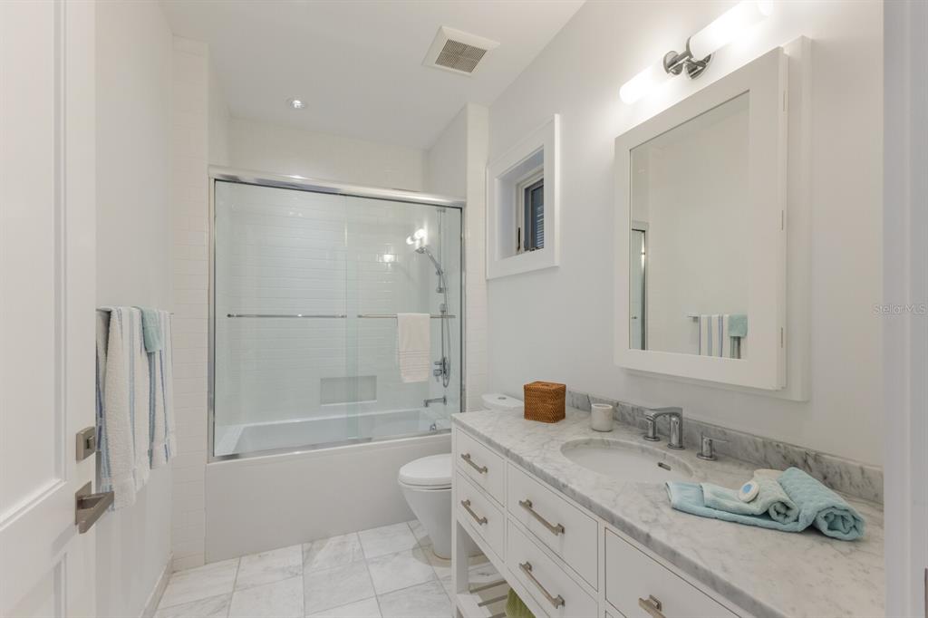 2031 Shore Lane Boca Grande, FL 33921 - Photo 45 of 100 a bathroom with a granite countertop sink a toilet and shower