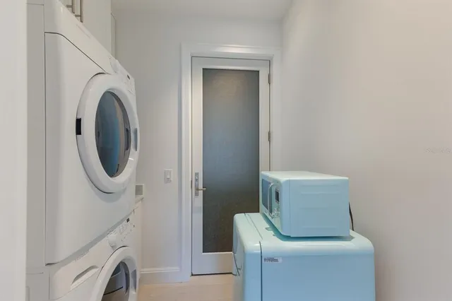 a utility room with sink dryer and washer