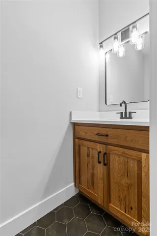 a bathroom with a sink vanity and a mirror