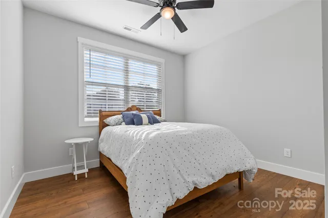 a bed sitting in a bedroom next to a window